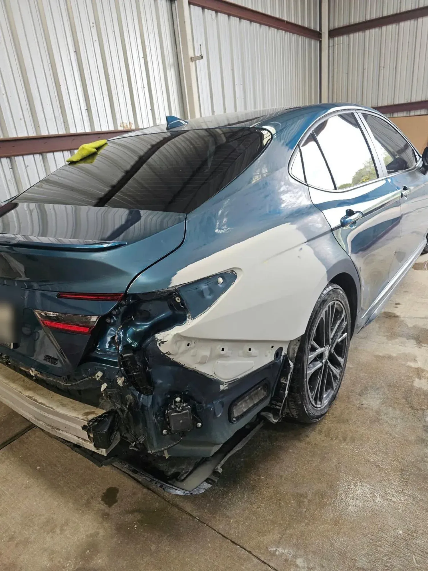 Toyota Camry with rear-end collision damage waiting for body work