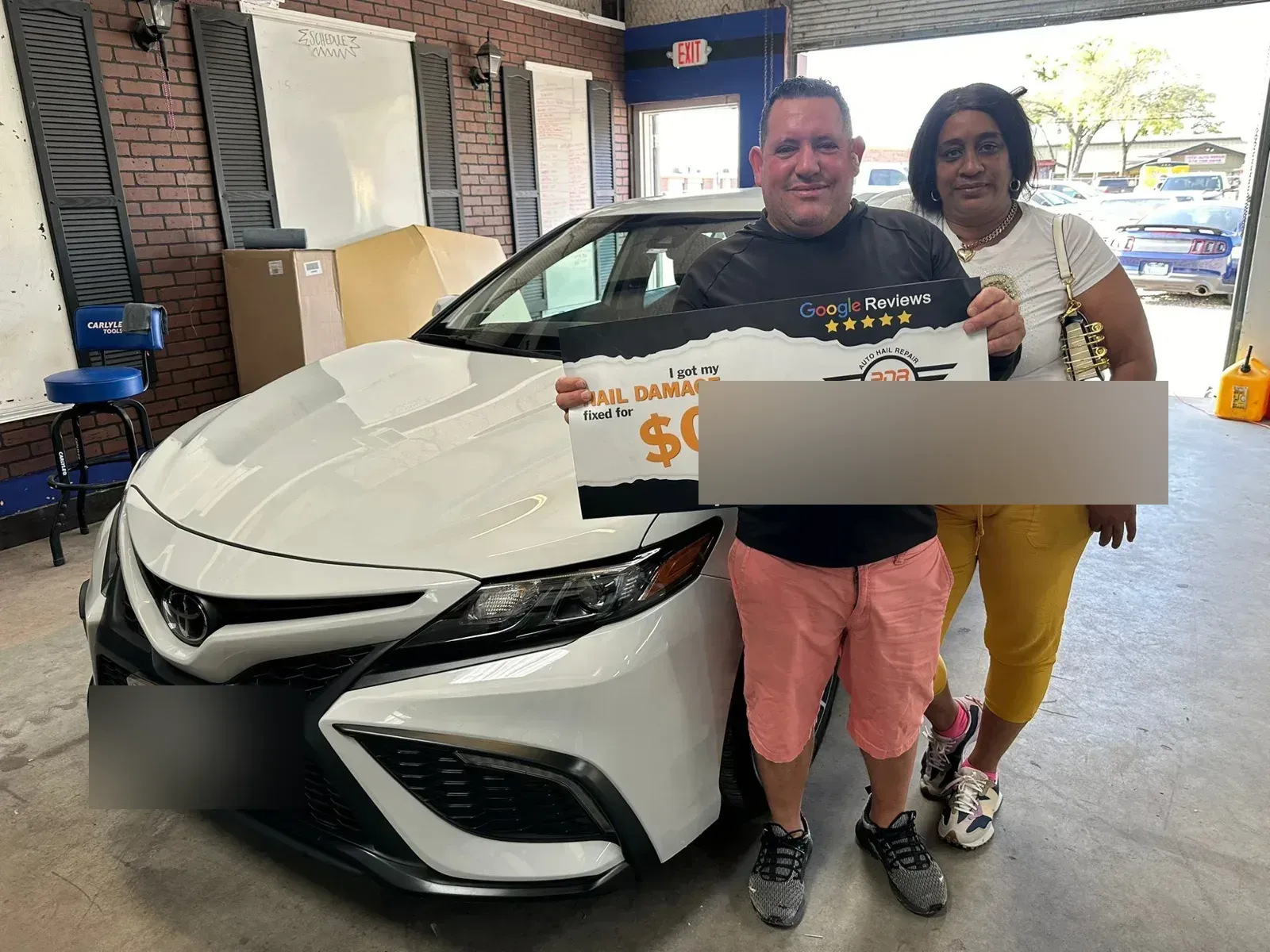 Couple with their white Toyota Camry after hail repair