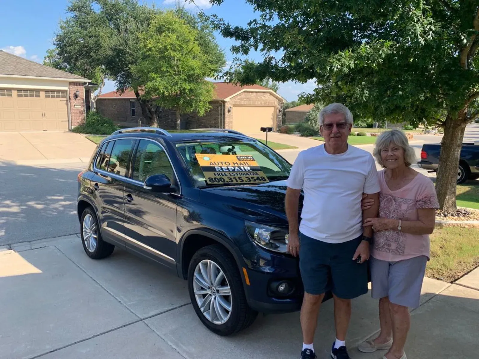 Couple with their Volkswagen Tiguan after hail repair