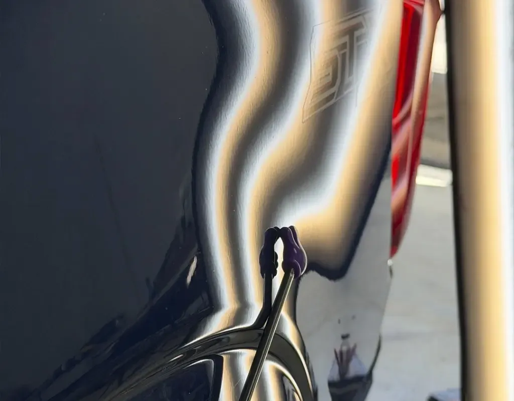 Quarter panel dent under a reflection board — after