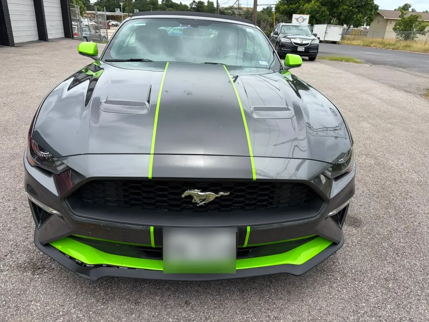Mustang hood with hail dents along the center stripe