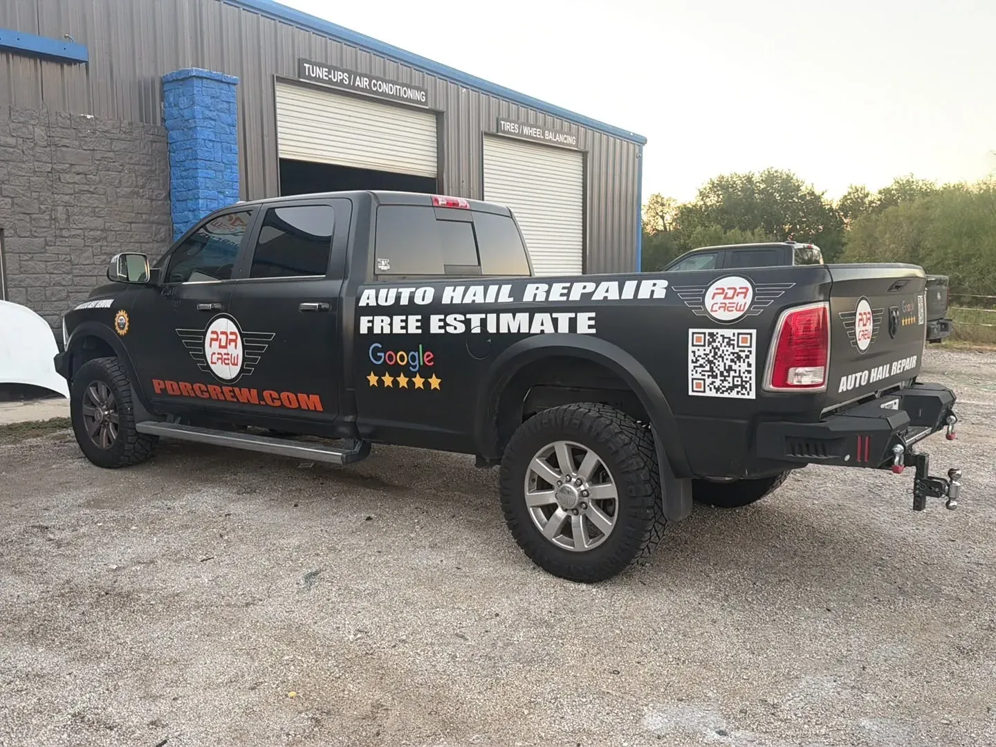 PDR Crew truck wrapped with Auto Hail Repair and Free Estimate, parked at the shop