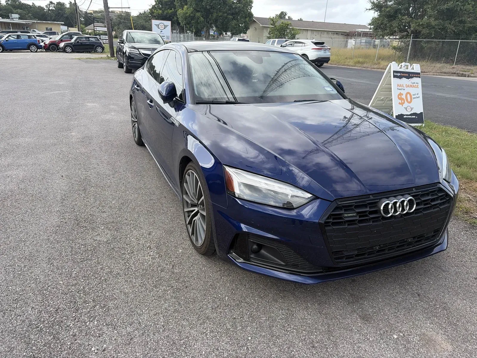 Blue Audi A5 outside the shop