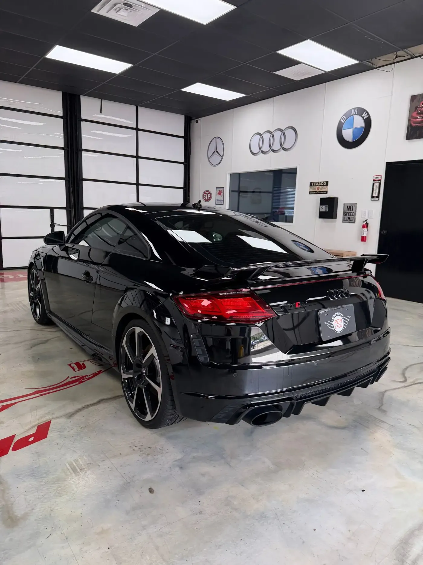 Black Audi TT RS with a mirror-like finish in the shop