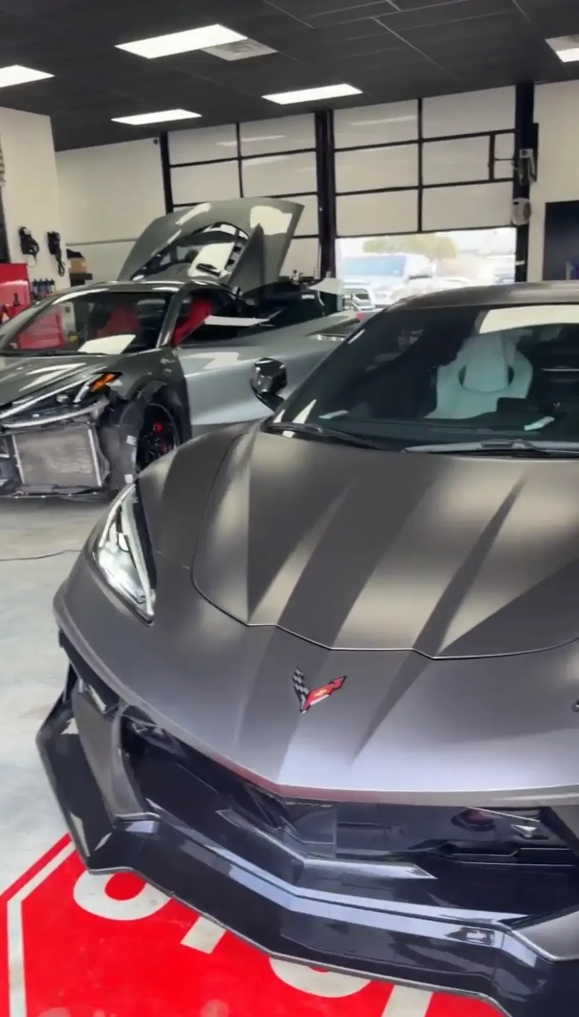 Corvette with the front end torn off waiting for body work